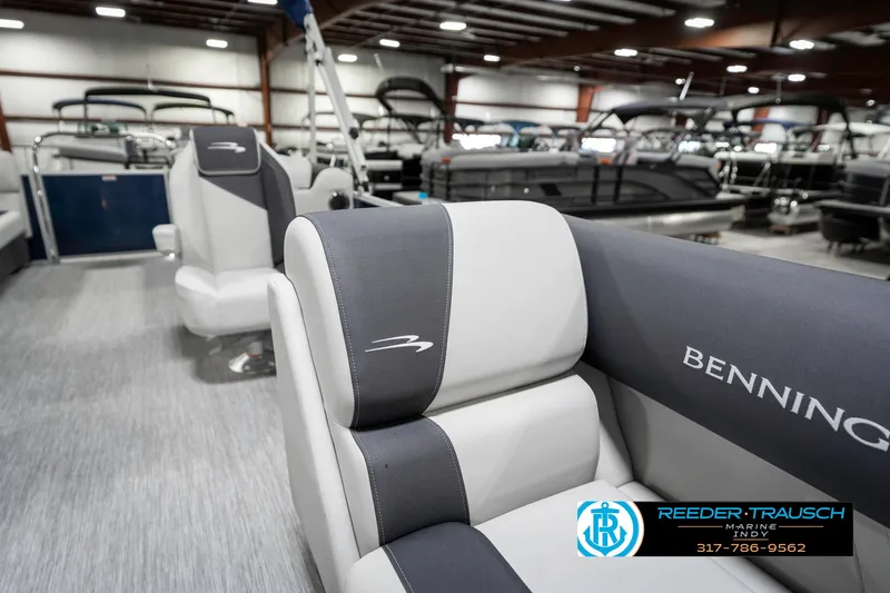 Slide: The Image of 2025 Bennington 22 SSR pontoon boat interior with gray and white seating in showroom. - 24