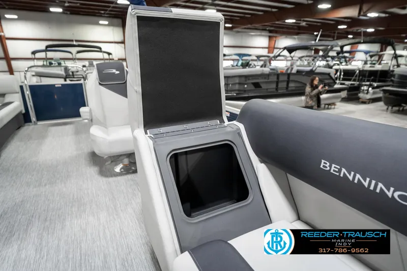 Slide: The Image of 2025 Bennington 22 SSR boat interior with open storage compartment in showroom. - 25