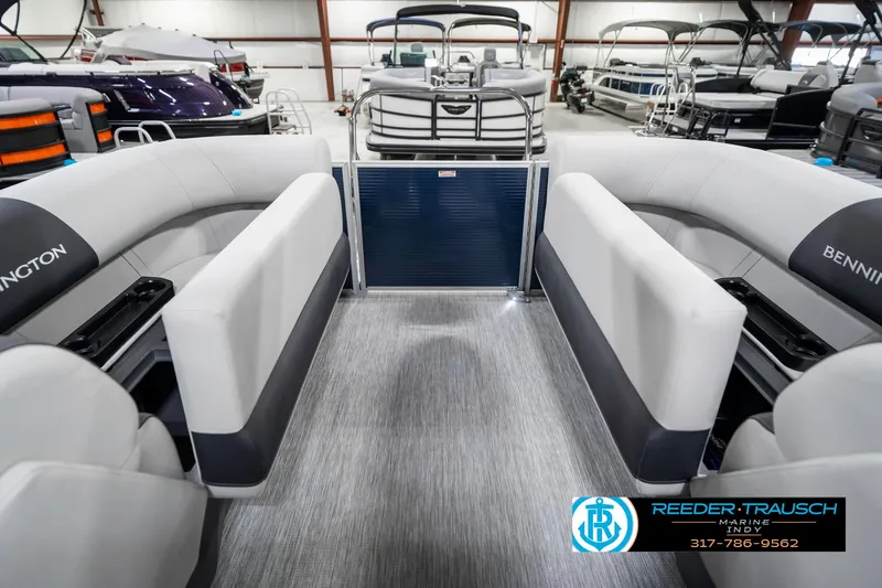 Slide: The Image of 2025 Bennington 22 SSR pontoon boat interior with gray seating, displayed at Reeder-Trausch Marine. - 27