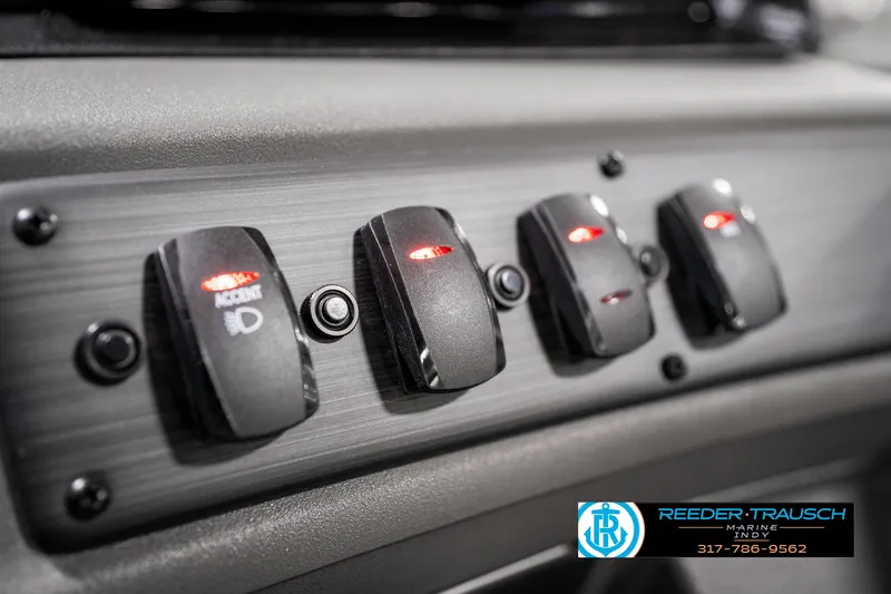 Slide: The Image of Dashboard switches of 2025 Bennington 22 SSR boat with illuminated indicators. - 35