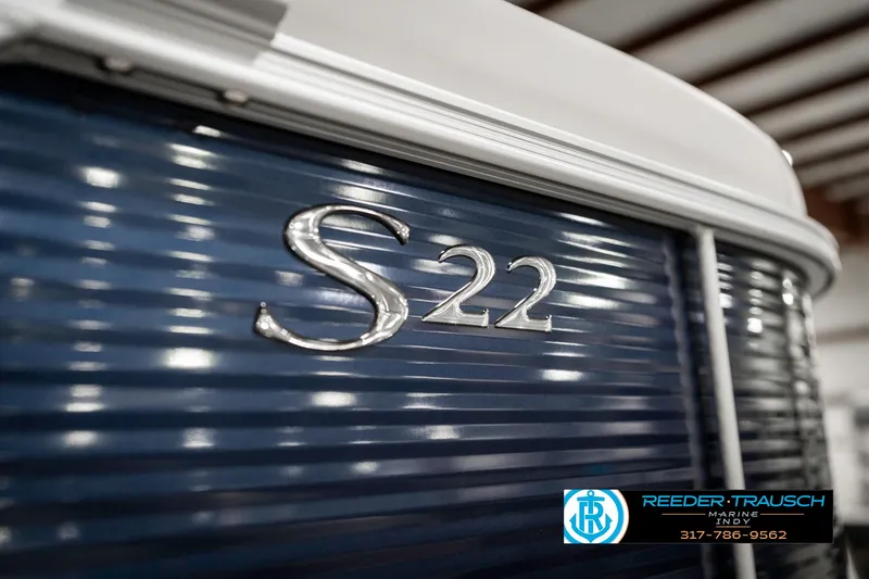 Slide: The Image of 2025 Bennington 22 SSR boat with blue paneling and "S22" emblem. - 49