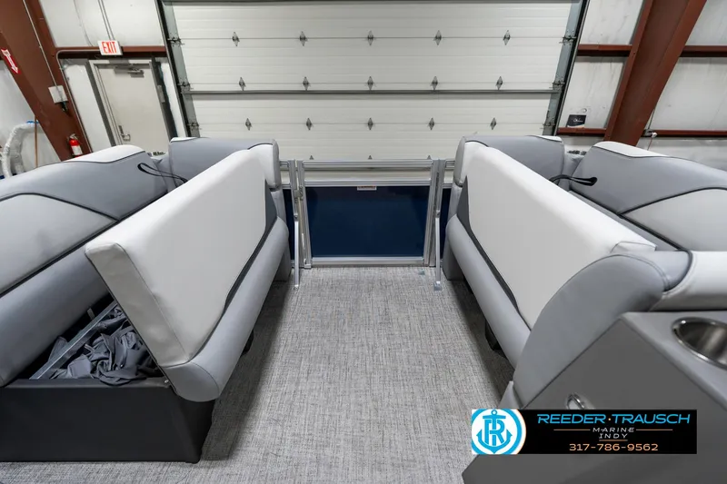 Slide: The Image of 2025 Avalon 1785 Venture CRB interior with gray seating and carpeted flooring in a showroom. - 21