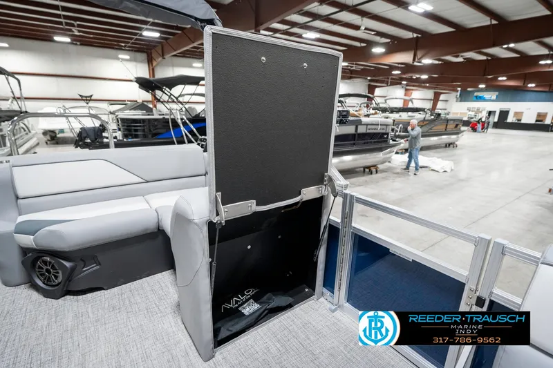 Slide: The Image of 2025 Avalon 1785 Venture CRB boat interior in showroom, featuring seating and storage. - 23