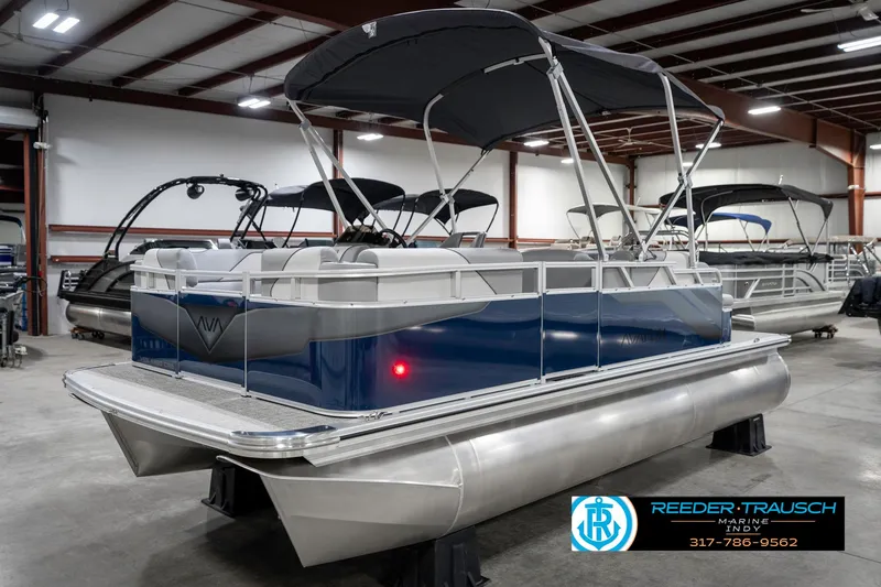 Slide: The Image of 2025 Avalon 1785 Venture CRB pontoon boat in showroom, featuring sleek design and canopy. - 3