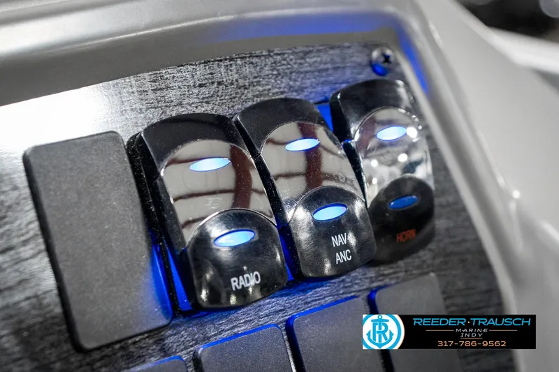 Slide: The Image of Control panel of 2025 Avalon 1785 Venture CRB with illuminated switches for radio and navigation. - 36