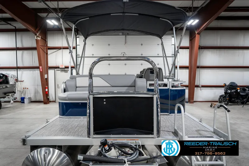 Slide: The Image of 2025 Avalon 1785 Venture CRB pontoon boat in a showroom with canopy and seating. - 8
