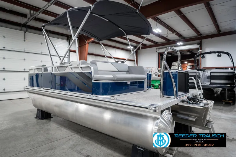Slide: The Image of 2025 Avalon 1785 Venture CRB pontoon boat in showroom with canopy and seating. - 9