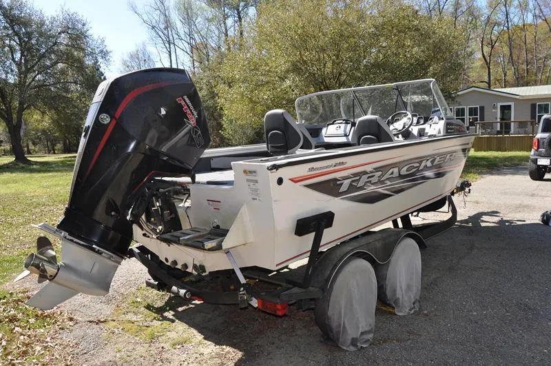 Slide: The Image of 2019 Tracker Targa V-19 Combo Tournament Edition boat on trailer, parked outdoors. - 3