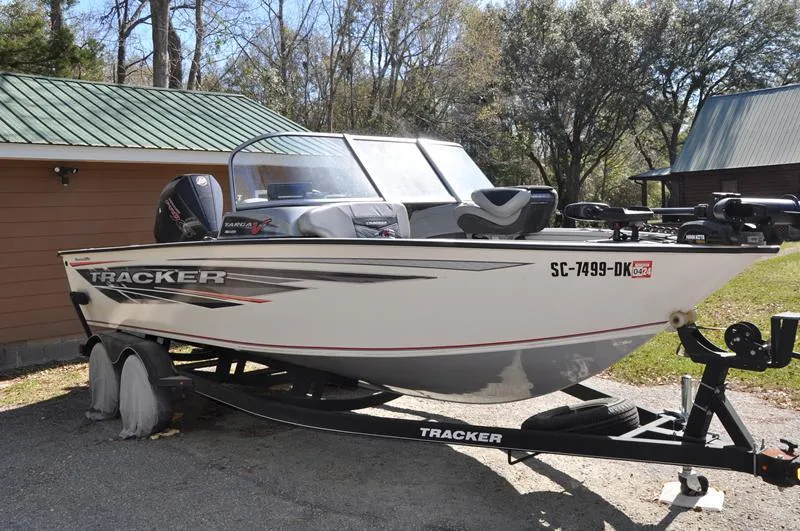 Slide: The Image of 2019 Tracker Targa V-19 Combo Tournament Edition boat on trailer, parked outdoors. - 5