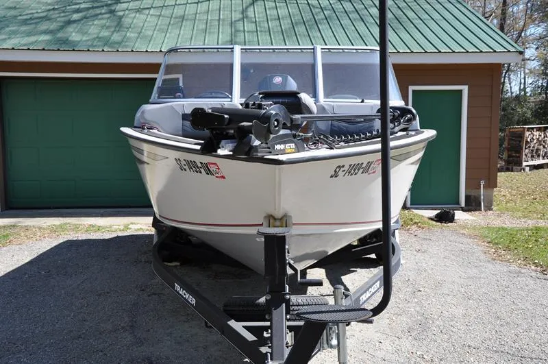 Slide: The Image of 2019 Tracker Targa V-19 Combo Tournament Edition boat on trailer, parked in driveway. - 6