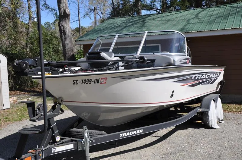 Slide: The Image of 2019 Tracker Targa V-19 Combo Tournament Edition boat on trailer, parked outdoors. - 7