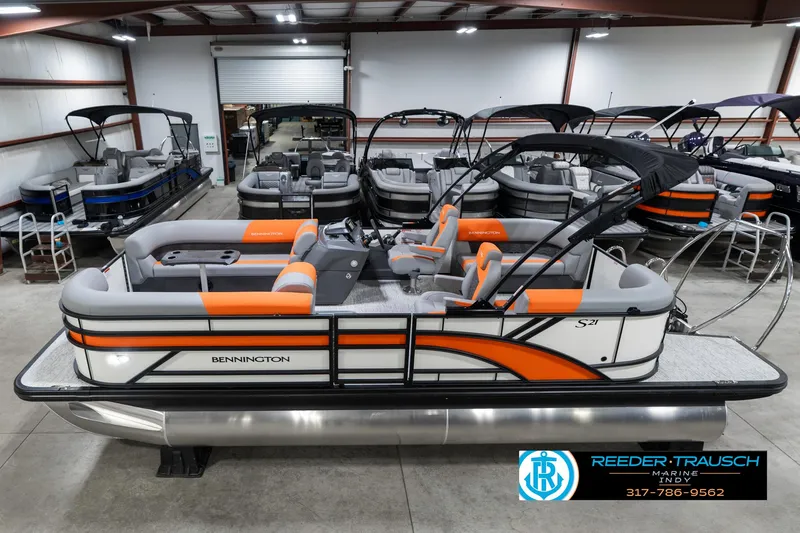 The Image of 2025 Bennington 21 SSR pontoon boat with orange accents in a showroom. - 0