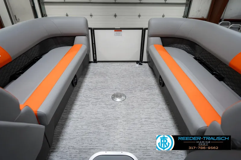 Slide: The Image of 2025 Bennington 21 SSR boat interior with gray and orange seating, spacious layout. - 21
