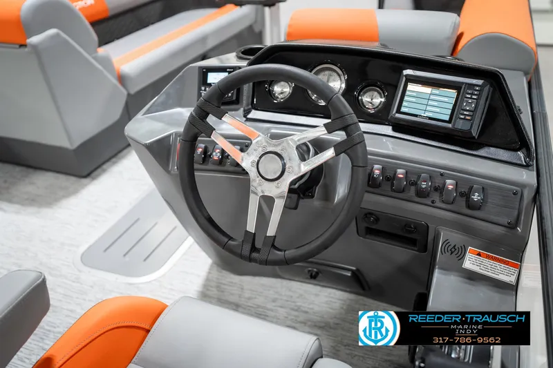 Slide: The Image of 2025 Bennington 21 SSR boat dashboard with steering wheel and modern controls. - 27