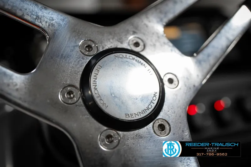 Slide: The Image of Steering wheel of 2025 Bennington 21 SSR boat, featuring metallic design and logo. - 29