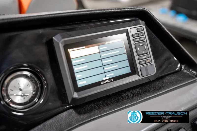 Slide: The Image of Garmin display on 2025 Bennington 21 SSR boat dashboard with clock and controls. - 33