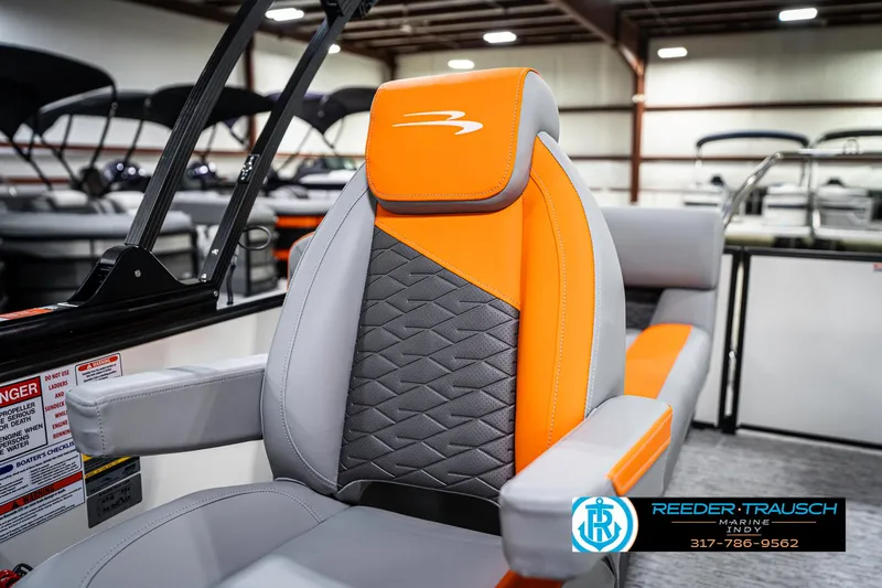 Slide: The Image of 2025 Bennington 21 SSR boat seat with orange and gray design in showroom. - 36