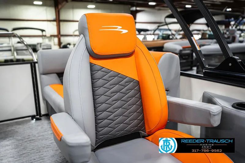 Slide: The Image of 2025 Bennington 21 SSR boat seat with orange and gray design in showroom setting. - 38