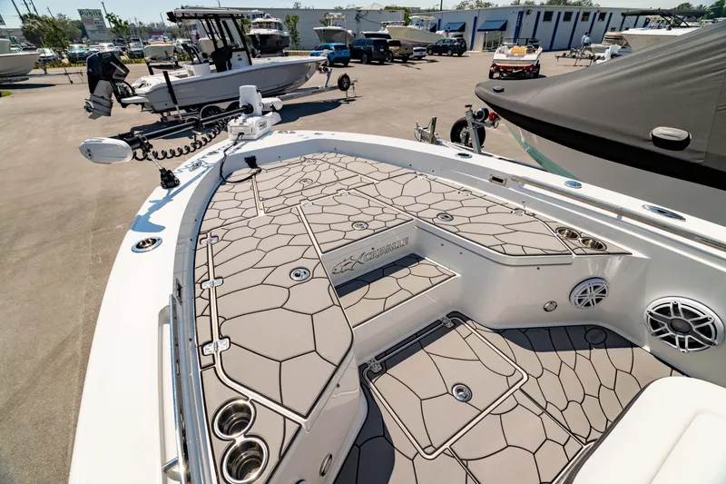Slide: The Image of 2024 Crevalle 26 HCO boat with spacious deck and modern design in a marina setting. - 1