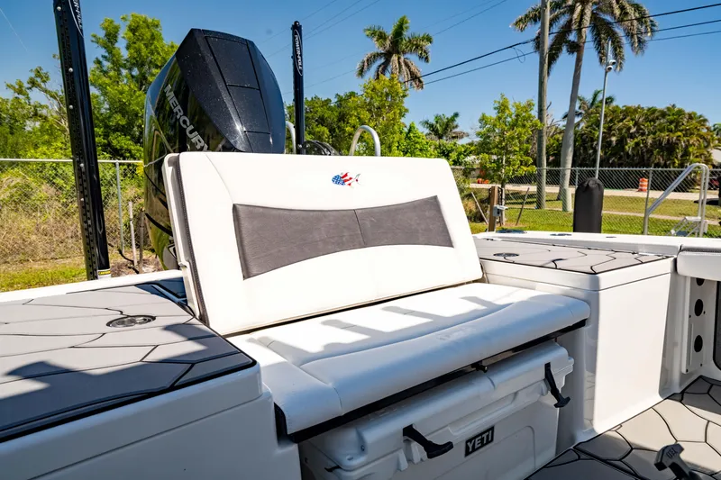 Slide: The Image of 2024 Crevalle 26 HCO boat interior with seating and Yeti cooler. - 17