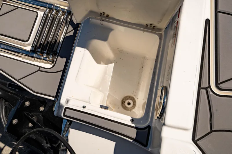 Slide: The Image of Open storage compartment on 2024 Crevalle 26 HCO boat, showing interior details. - 19