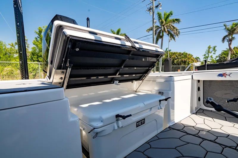 Slide: The Image of 2024 Crevalle 26 HCO boat with open storage compartment and Yeti cooler. - 20