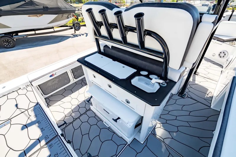 Slide: The Image of 2024 Crevalle 26 HCO boat interior with fishing rod holders and storage compartments. - 22