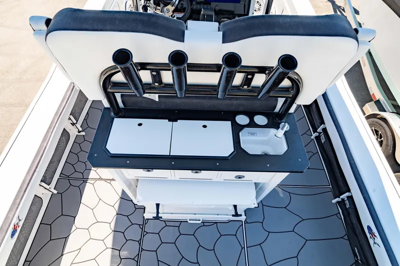 Slide: The Image of 2024 Crevalle 26 HCO boat interior with rod holders and storage compartments. - 23