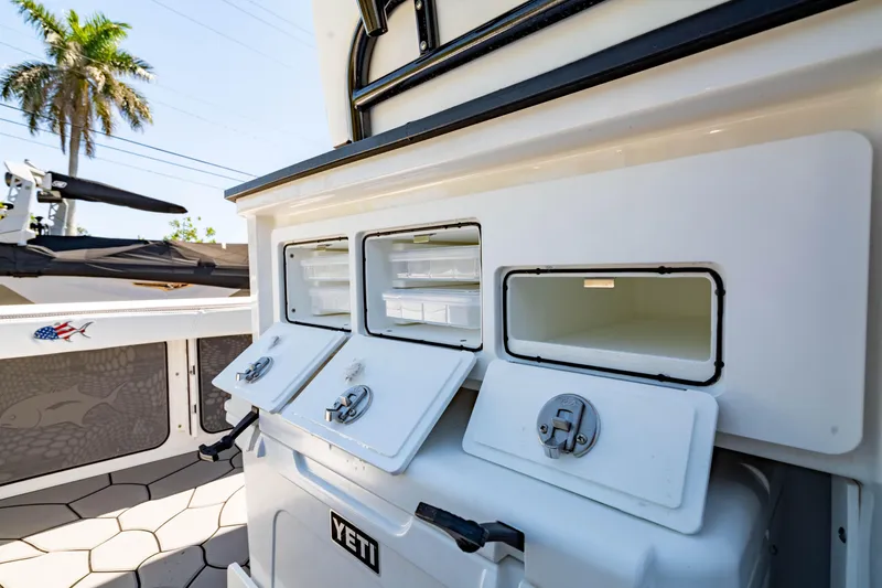 Slide: The Image of 2024 Crevalle 26 HCO boat with Yeti cooler and storage compartments. - 24