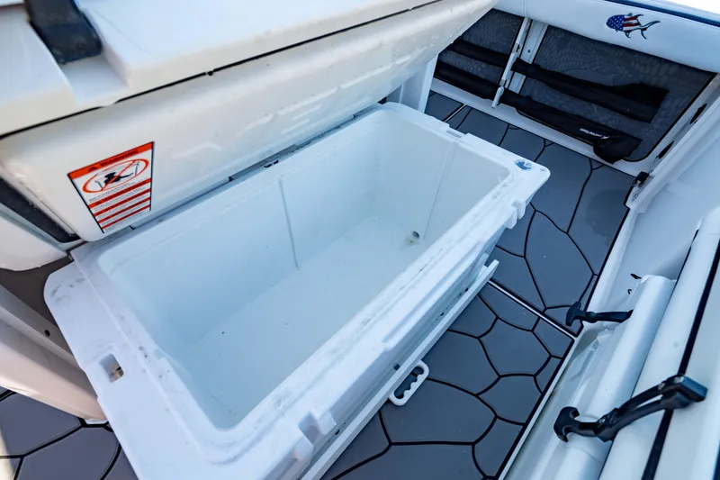 Slide: The Image of 2024 Crevalle 26 HCO boat with open storage compartment and non-slip flooring. - 25
