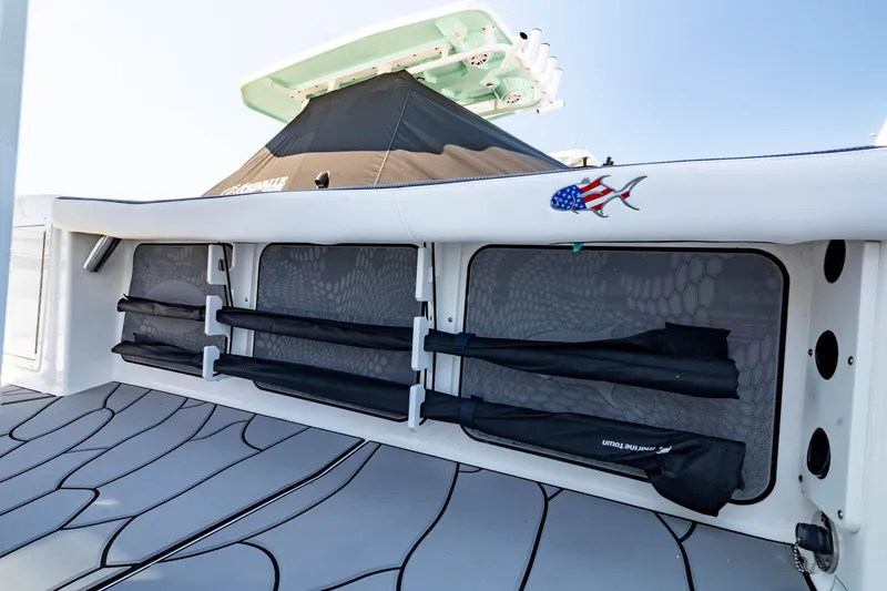 Slide: The Image of 2024 Crevalle 26 HCO boat with rod storage and American flag fish decal. - 26