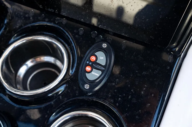 Slide: The Image of Control panel and cup holders on 2024 Crevalle 26 HCO boat dashboard. - 28