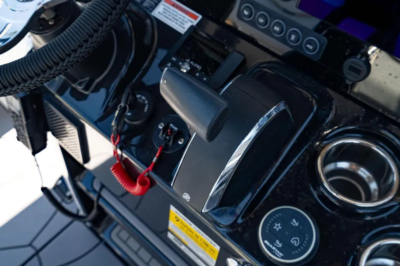 Slide: The Image of 2024 Crevalle 26 HCO boat dashboard with throttle, steering wheel, and control panel. - 29