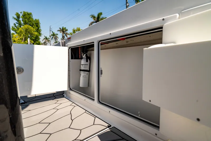 Slide: The Image of 2024 Crevalle 26 HCO boat storage compartment with open hatch, showcasing interior space. - 43