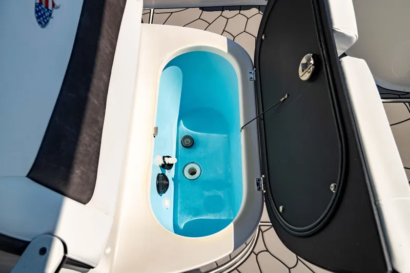 Slide: The Image of 2024 Crevalle 26 HCO boat livewell with open lid, showcasing interior features. - 48