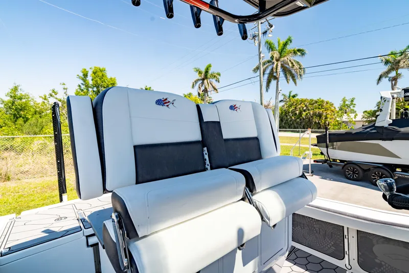 Slide: The Image of 2024 Crevalle 26 HCO boat seats with palm trees in the background. - 5