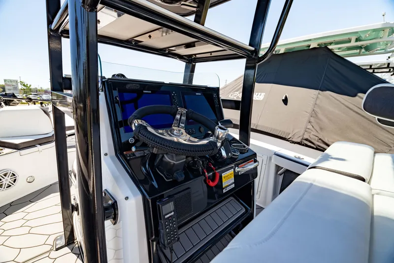 Slide: The Image of 2024 Crevalle 26 HCO boat console with steering wheel and controls. - 6