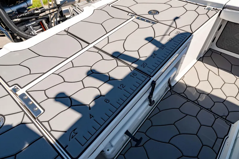 Slide: The Image of 2024 Crevalle 26 HCO boat deck with measuring ruler and textured flooring. - 9