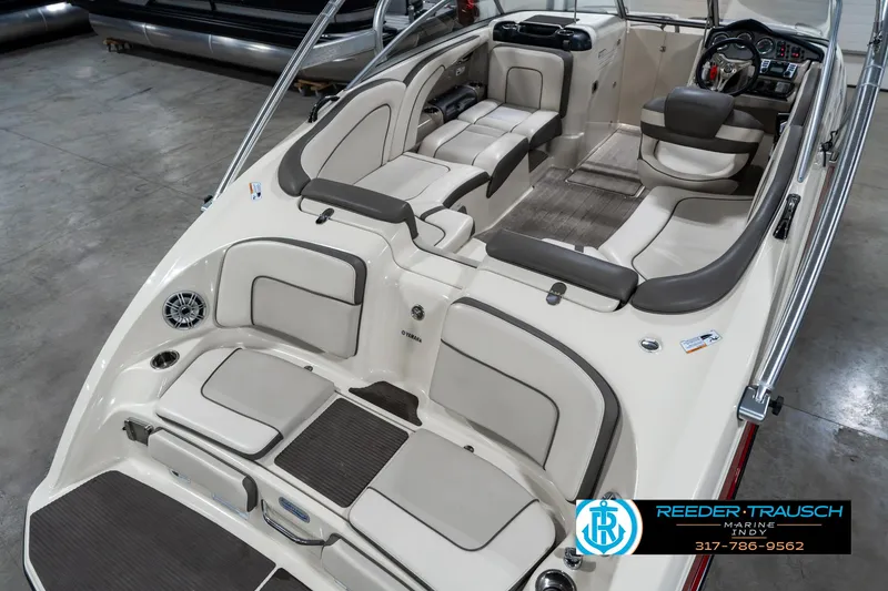 Slide: The Image of 2014 Yamaha Boats 242 Limited S interior with spacious seating and modern dashboard. - 14