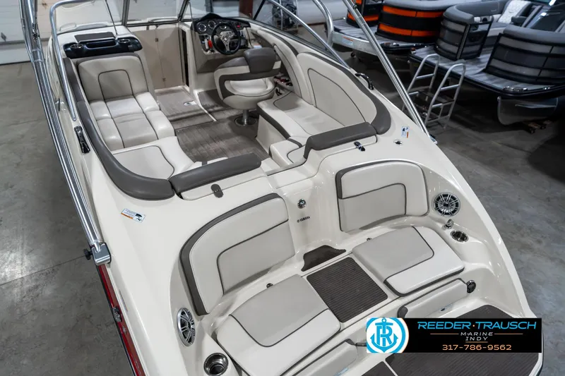 Slide: The Image of 2014 Yamaha Boats 242 Limited S interior with spacious seating and modern dashboard. - 15