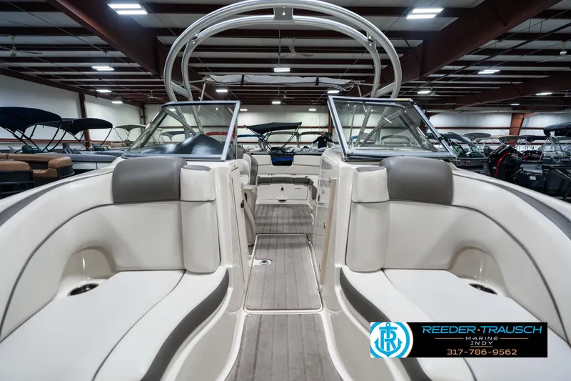 Slide: The Image of 2014 Yamaha Boats 242 Limited S interior with seating, showcased in a showroom. - 18