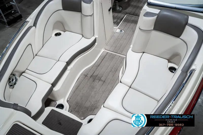 Slide: The Image of 2014 Yamaha Boats 242 Limited S interior with white and gray seating, wood-style flooring. - 20