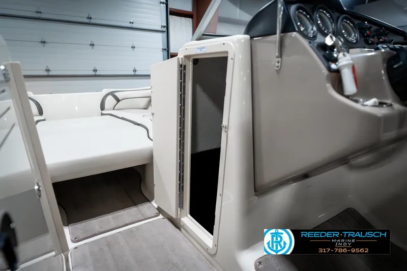 Slide: The Image of 2014 Yamaha Boats 242 Limited S interior with open storage compartment and seating. - 26
