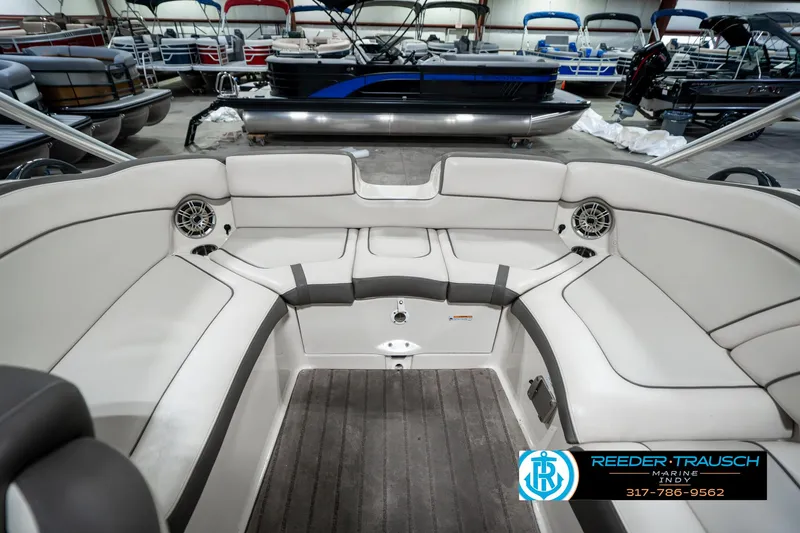 Slide: The Image of 2014 Yamaha Boats 242 Limited S interior with spacious seating in a showroom. - 29