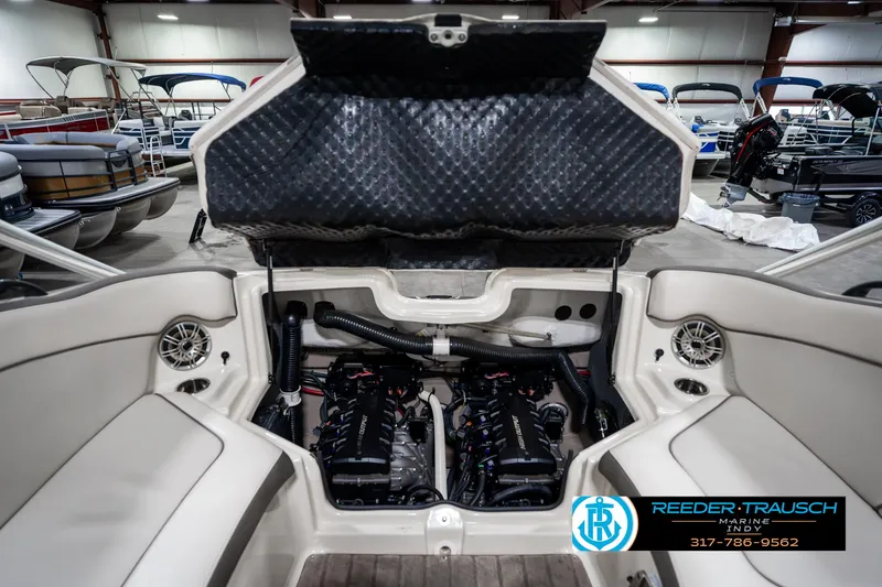 Slide: The Image of 2014 Yamaha Boats 242 Limited S engine compartment in showroom, showcasing dual engines and seating. - 31