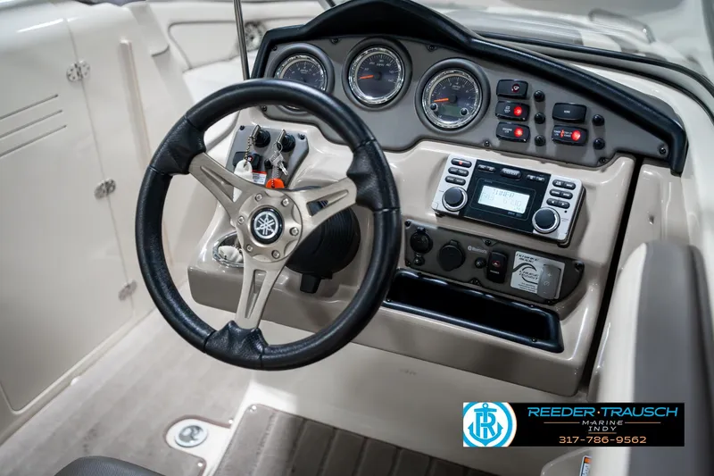 Slide: The Image of 2014 Yamaha Boats 242 Limited S dashboard with steering wheel and control panel. - 32