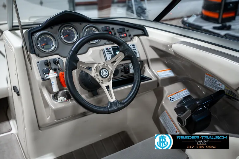 Slide: The Image of 2014 Yamaha Boats 242 Limited S dashboard with steering wheel and controls. - 33