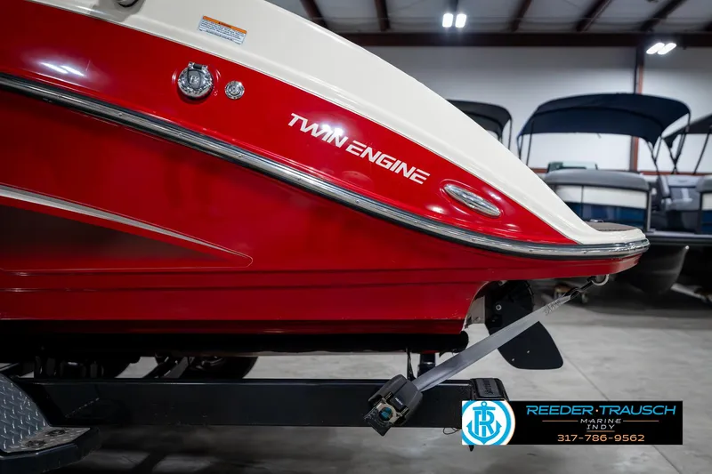 Slide: The Image of 2014 Yamaha Boats 242 Limited S, red twin-engine boat on trailer in showroom. - 49