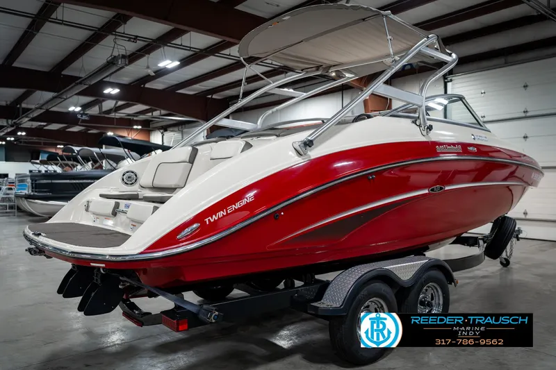 Slide: The Image of 2014 Yamaha Boats 242 Limited S in showroom, red and white, on trailer. - 8