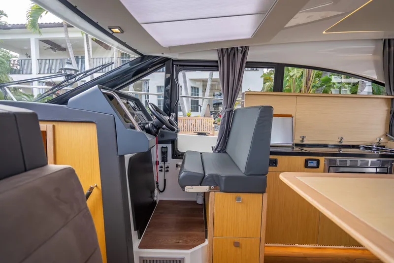 Slide: The Image of Interior of 2021 Skamander Monaco yacht with modern helm and kitchen area. - 10